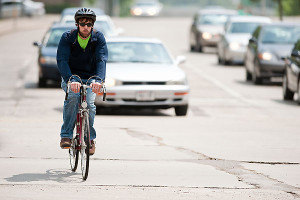 During Bike to Work Week, a cyclist makes his way along Park Street on the University of Wisconsin-Madison campus on June 8, 2009. Bike to Work Week, an annual promotion sponsored by the Bicycle Federation of Wisconsin, encourages commuters to try a two-wheeled alternative to driving and features events including morning snacks, bike tune-ups and an end-of-week celebration of cycling at Vilas Park. ©UW-Madison University Communications 608/262-0067 Photo by: Bryce Richter Date: 06/09 File#: NIKON D3 digital frame